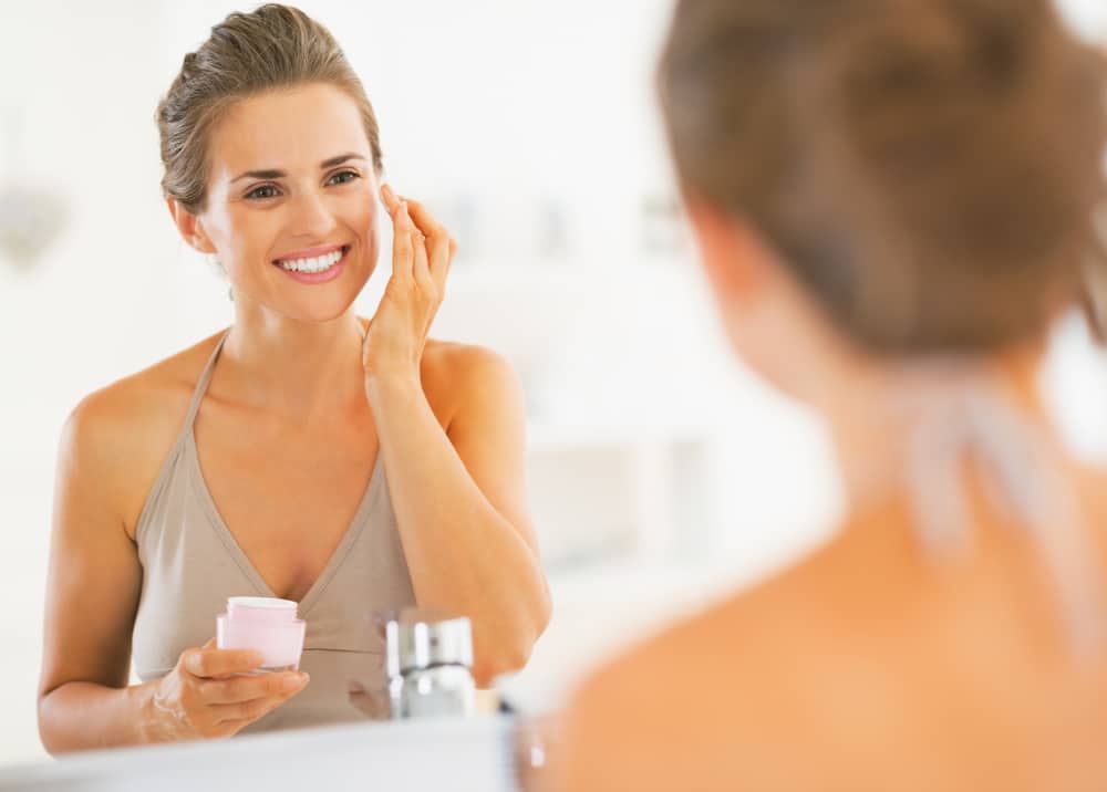 Woman applying anti-wrinkle cream instead of using dermal filler