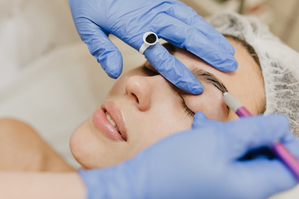 Woman getting botox eyebrow lift injection